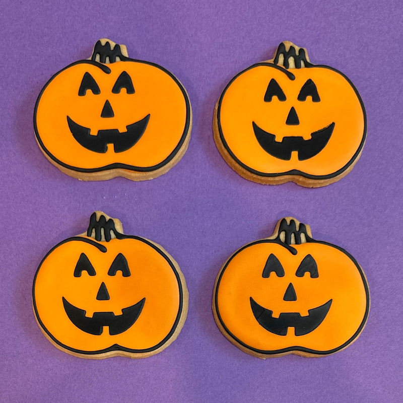 Pumpkin cookies with black jack o lantern faces